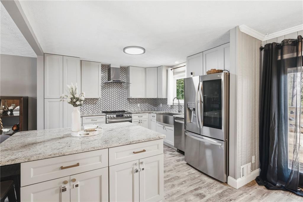 2470 Northbrook Road Snellville, GA 30039 - Photo 8 of 29 a kitchen with stainless steel appliances granite countertop a refrigerator and a sink