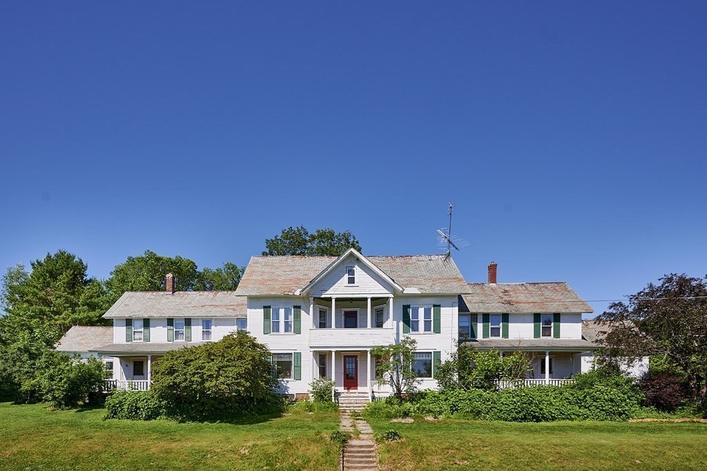 211 Greenfield Road Colrain, MA 01340 - Photo 2 of 34 a front view of a house with a yard