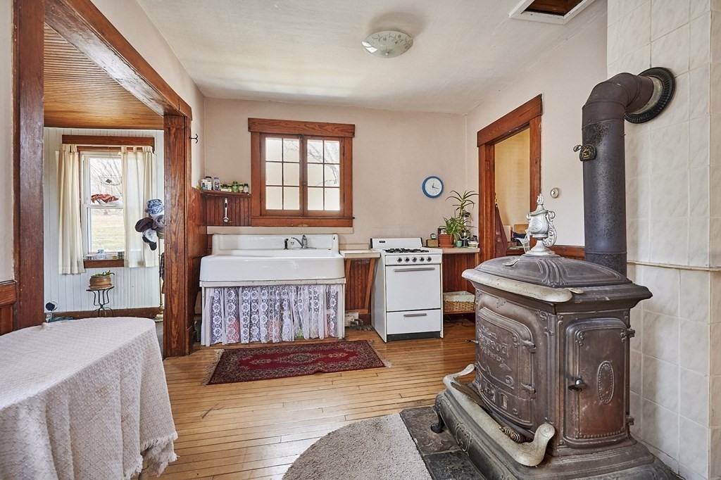 211 Greenfield Road Colrain, MA 01340 - Photo 8 of 34 a living room with furniture a fireplace and a large window