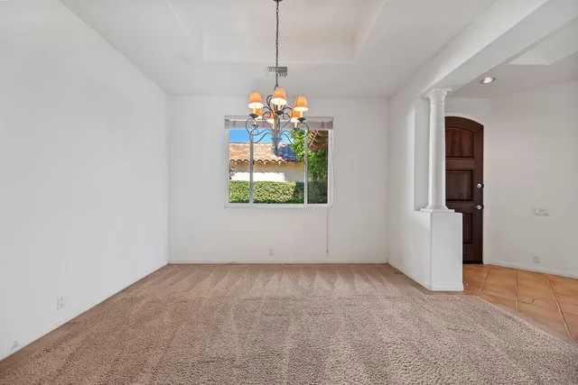 an empty room with window and hallway