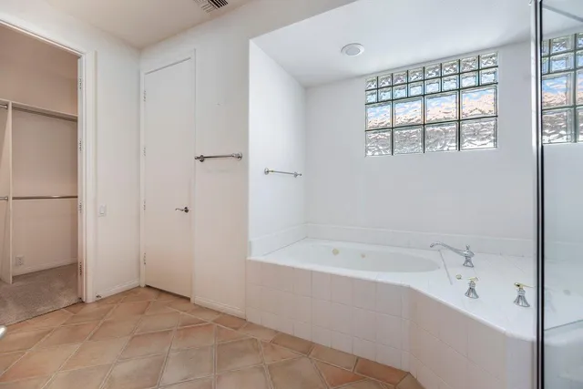 a spacious bathroom with a bathtub and a shower