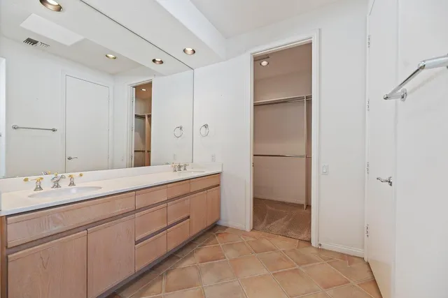 a bathroom with a double vanity sink mirror and double