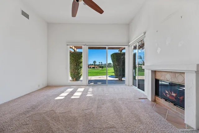 an empty room with furniture and a fireplace