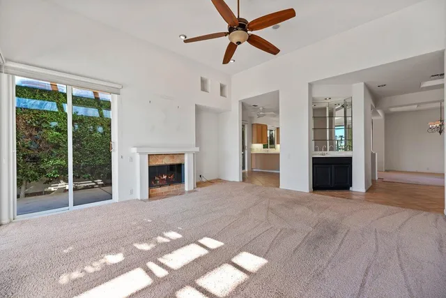 a view of a livingroom with a fireplace and window