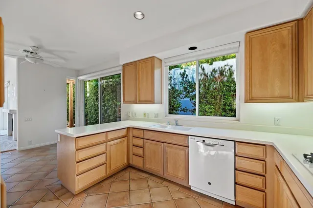 a kitchen with a sink window and cabinets