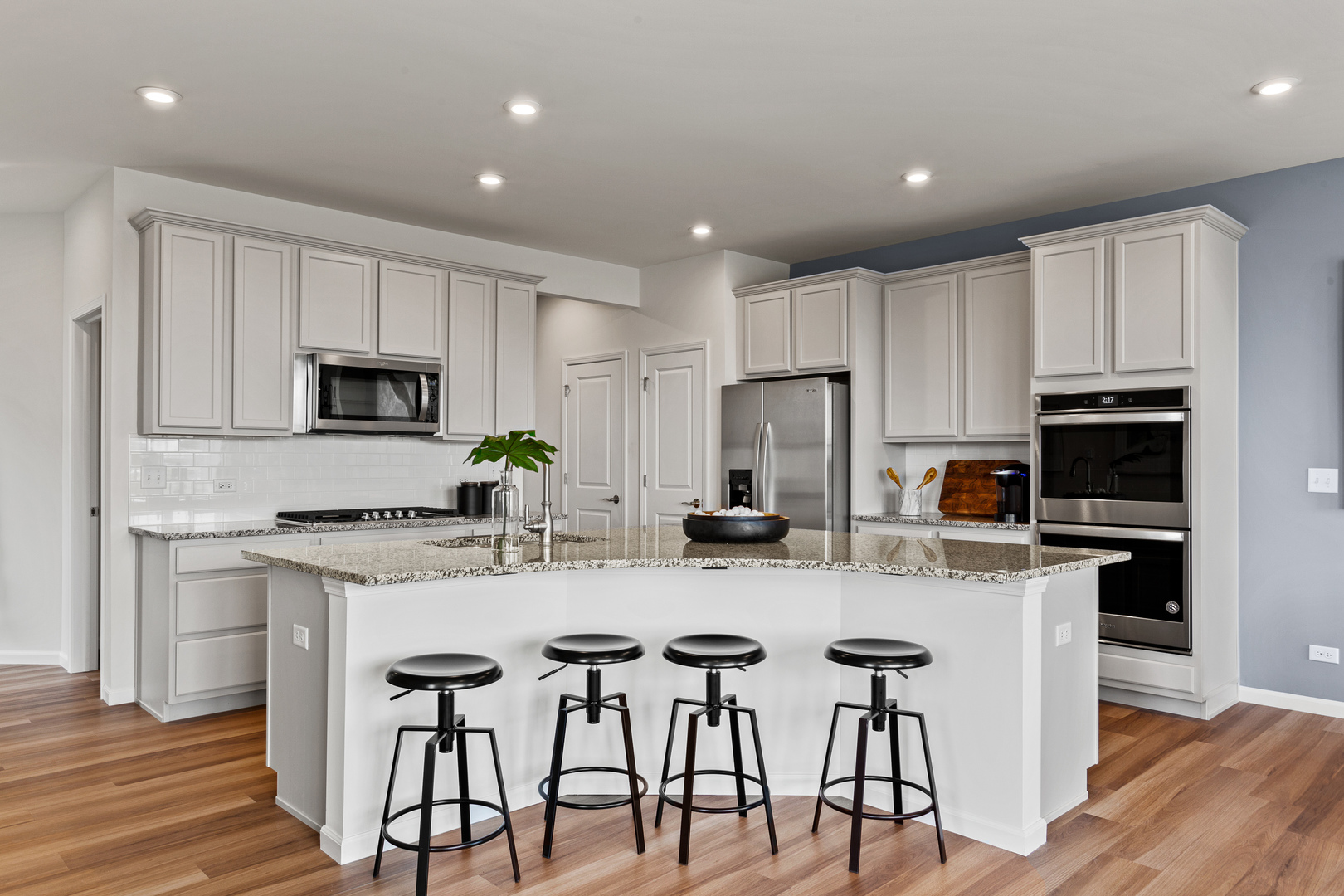 2108 Weatherbee Lane Naperville, IL 60563 - Photo 9 of 19 a kitchen with white cabinets and stainless steel appliances