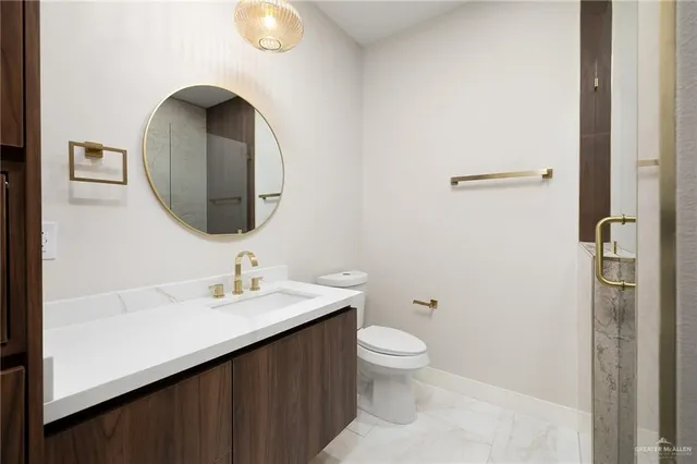 a bathroom with a toilet sink and mirror