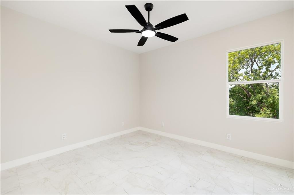 2705 East Solar Drive Mission, TX 78574 - Photo 15 of 16 an empty room with a window and a fan