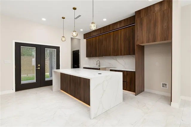 a kitchen with kitchen island cabinets and oven