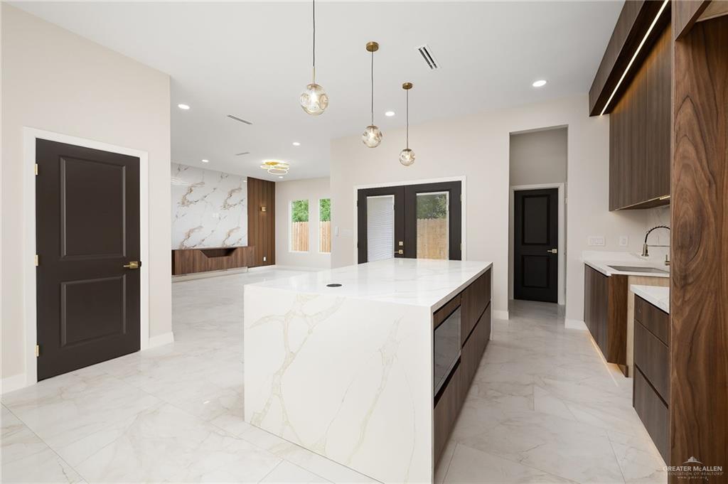 2705 East Solar Drive Mission, TX 78574 - Photo 6 of 16 a large kitchen with a large counter top stainless steel appliances