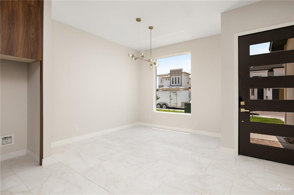2705 East Solar Drive Mission, TX 78574 - Photo 7 of 16 a view of an empty room with shelves and a window