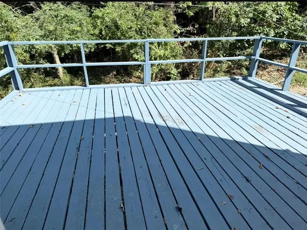 a view of balcony with wooden floor