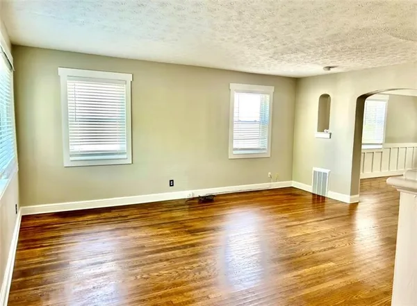 a view of a room with wooden floor and windows