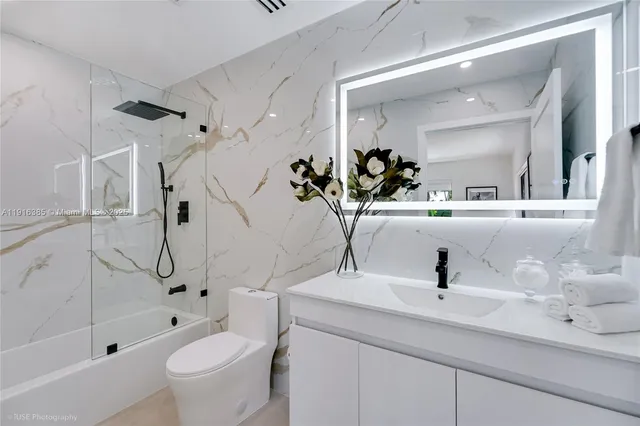 a bathroom with a sink toilet and shower