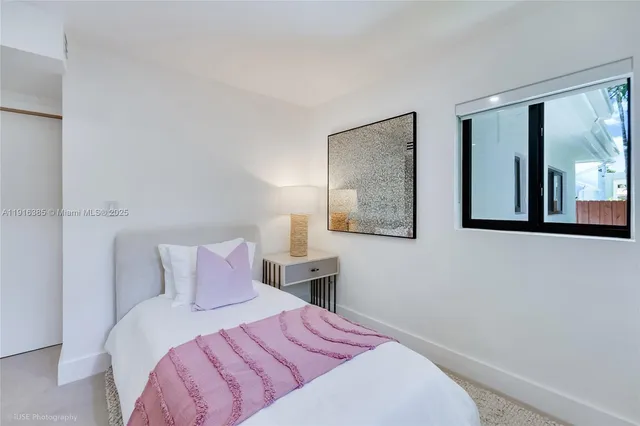 a bedroom with a bed and glass windows