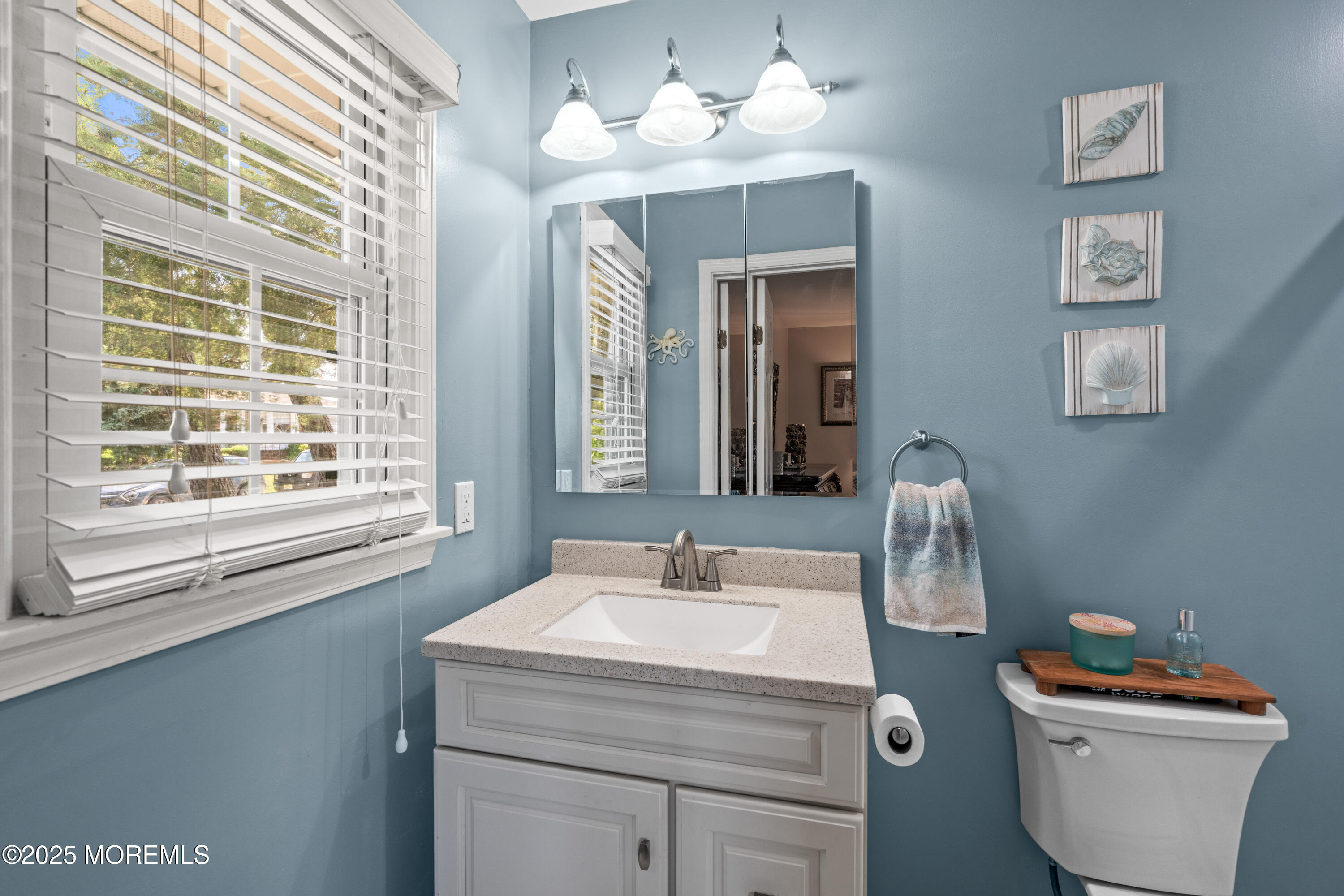 611 Drum Point Road Brick, NJ 08723 - Photo 13 of 35 a bathroom with a sink a toilet and a mirror