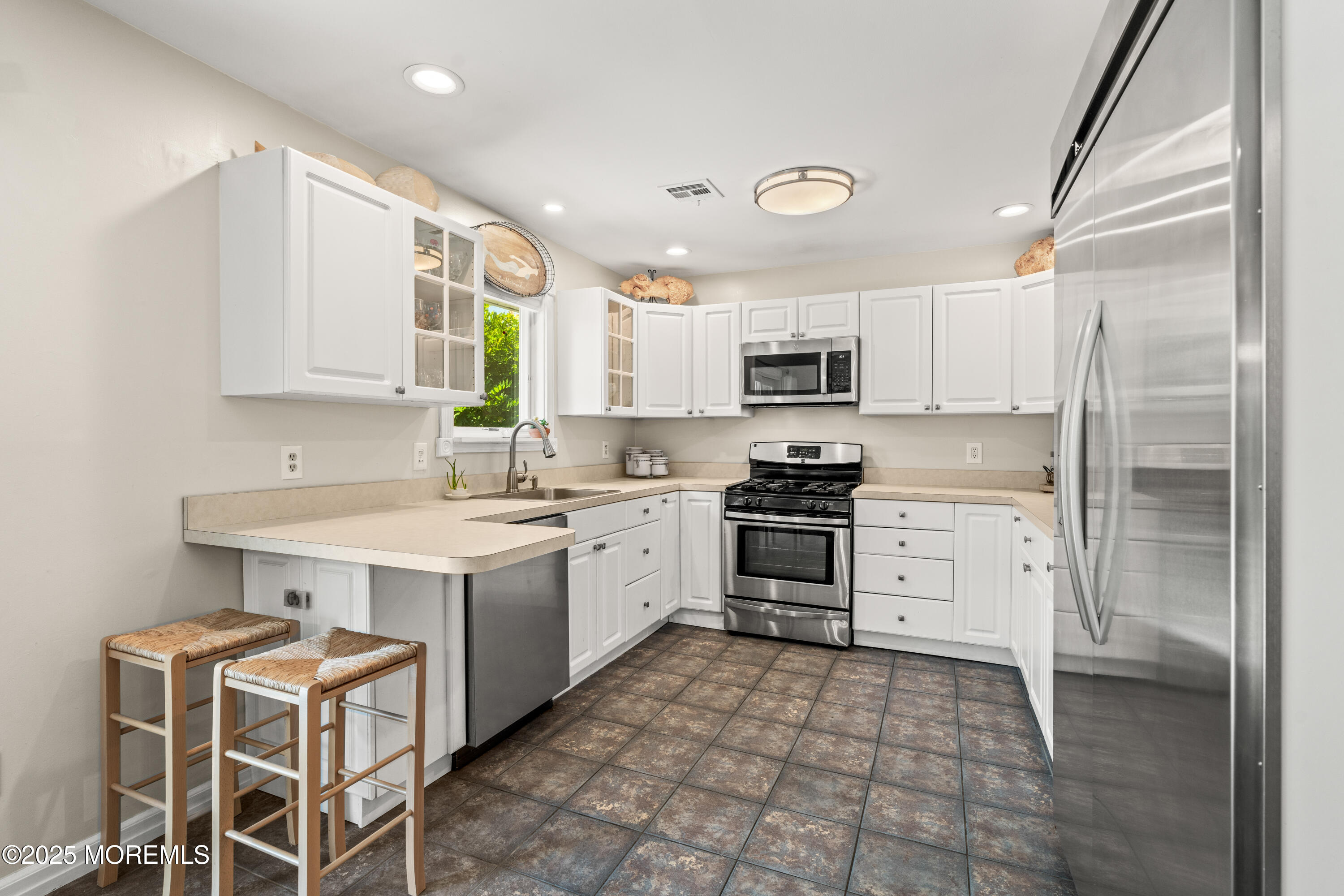 611 Drum Point Road Brick, NJ 08723 - Photo 8 of 35 a kitchen with a stove a sink and a refrigerator