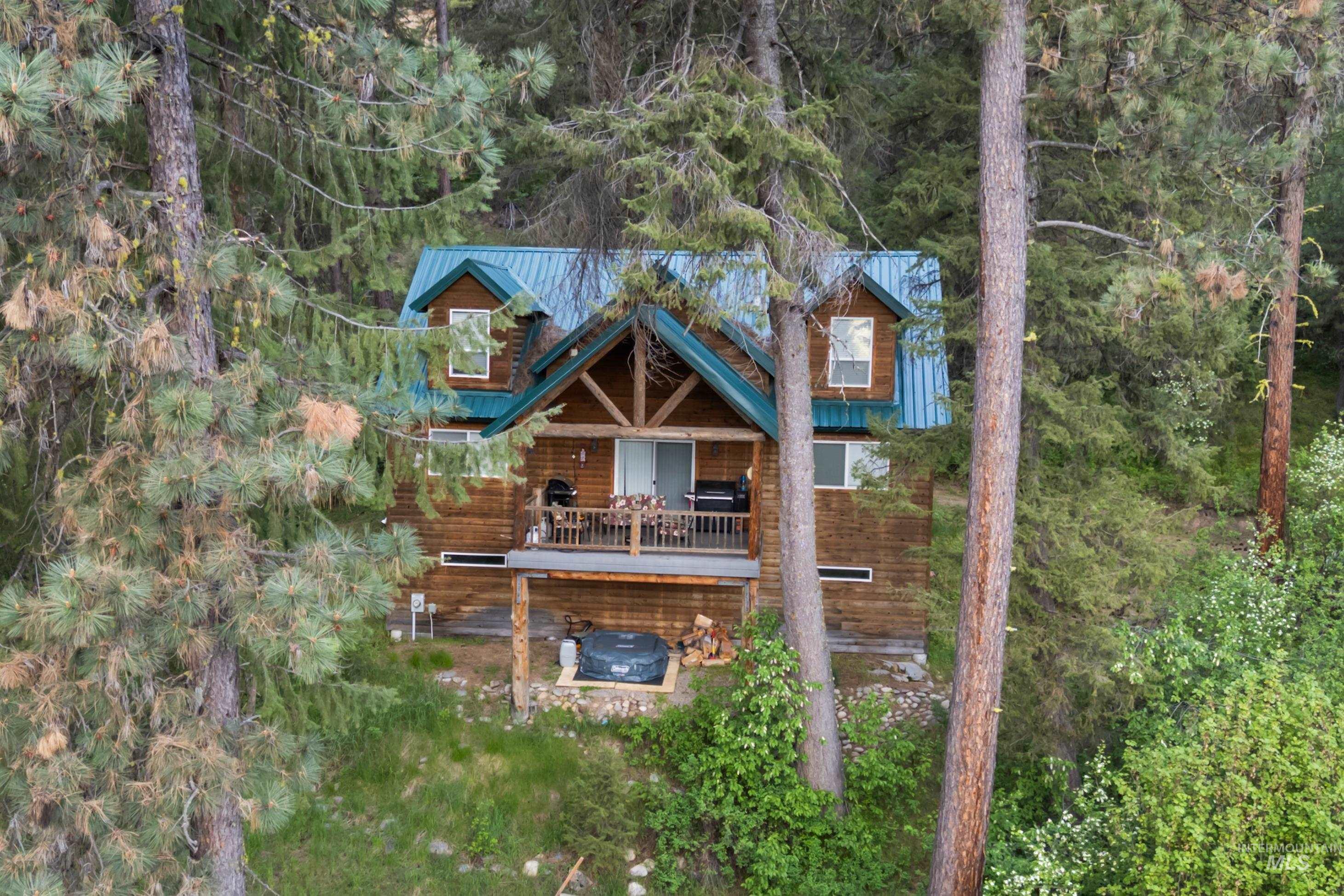 9 Deer Valley Road Garden Valley, ID 83622 - Photo 5 of 22 Cabin-style residence featuring natural wood siding and a teal metal roof