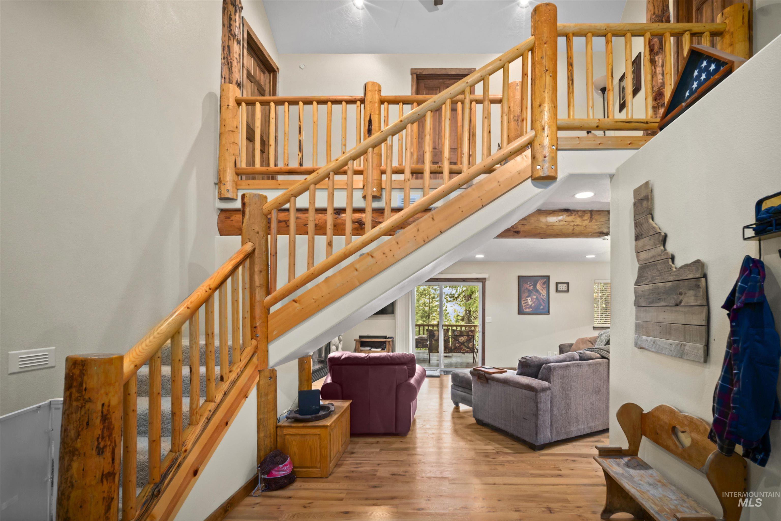 9 Deer Valley Road Garden Valley, ID 83622 - Photo 8 of 22 Multi-level interior featuring a natural wood staircase with log newel posts and railings