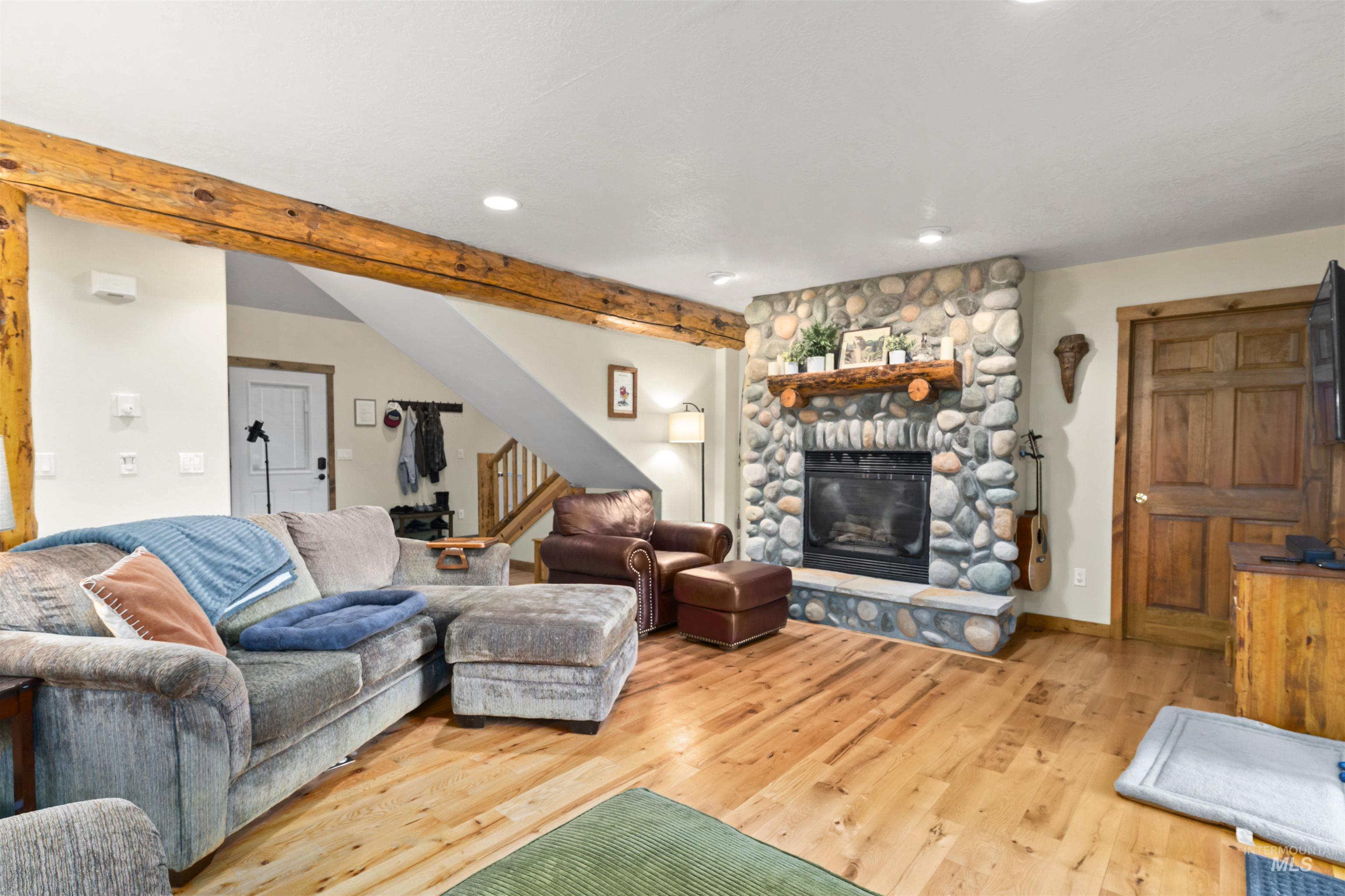 9 Deer Valley Road Garden Valley, ID 83622 - Photo 9 of 22 River rock fireplace with a wood mantel