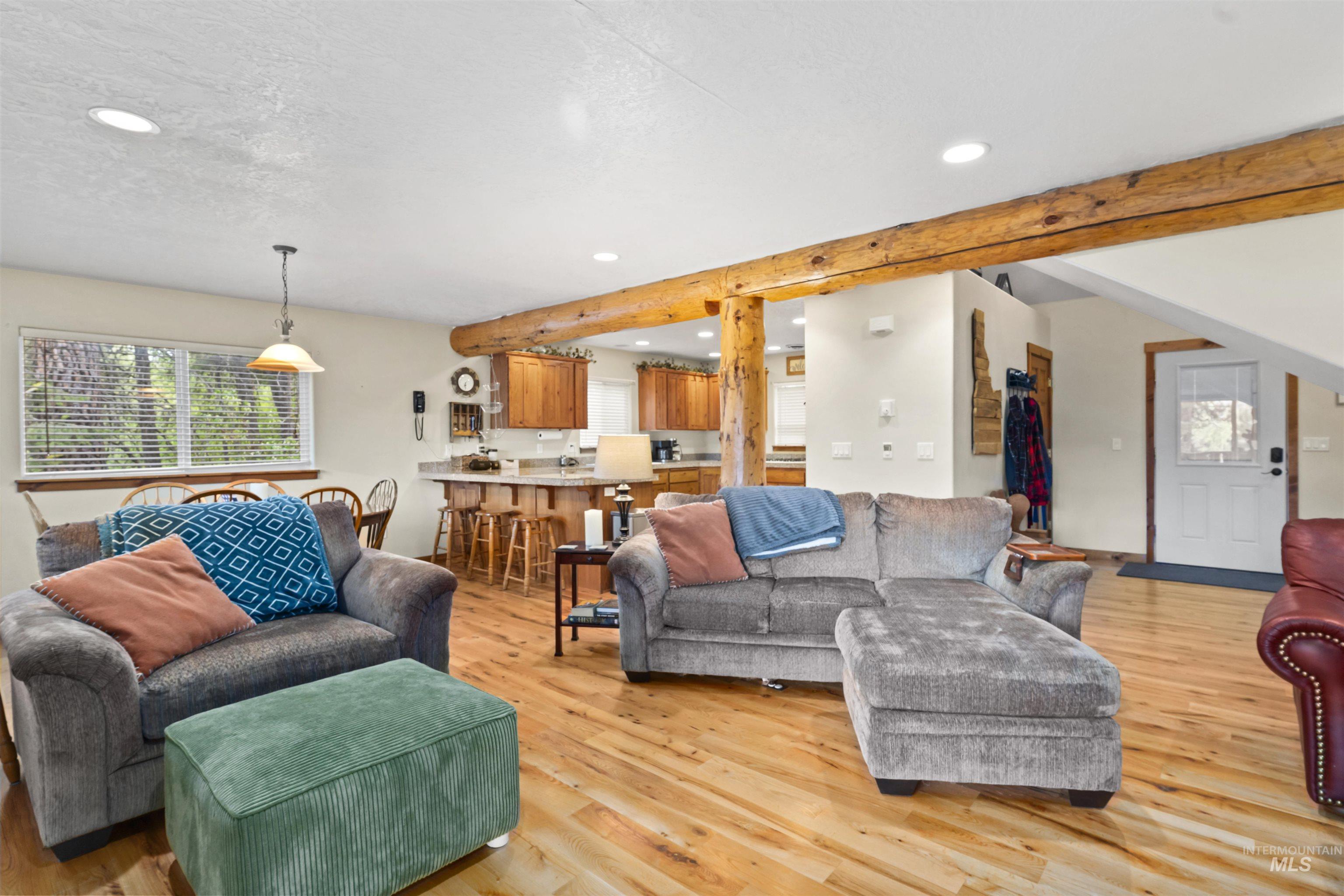 9 Deer Valley Road Garden Valley, ID 83622 - Photo 10 of 22 Open-concept living space featuring wood-finish flooring and exposed timber beams