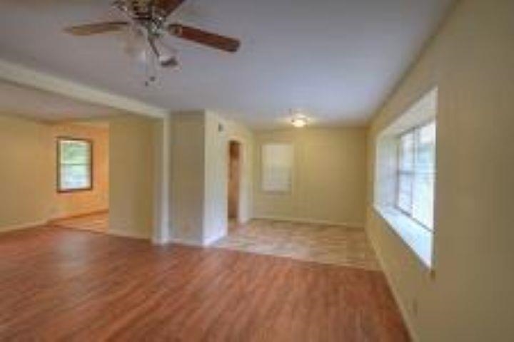 932 Cullenwood Road Memphis, TN 38116 - Photo 2 of 8 Wood-finish flooring throughout, ceiling fan with integrated lighting, recessed lighting, and multiple windows providing ambient illumination