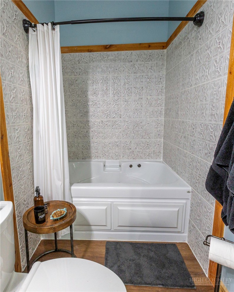 509 Grant Houck Road Todd, NC 28684 - Photo 33 of 43 a bathroom with a bathtub and a shower