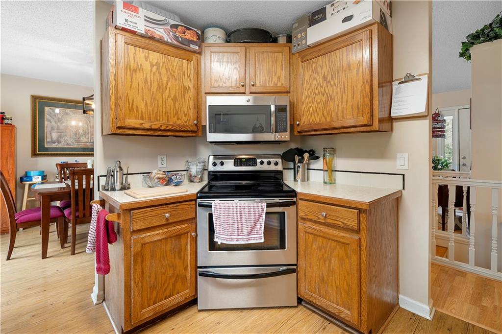 30 Azalea Drive Southeast Cartersville, GA 30121 - Photo 11 of 35 a kitchen with stainless steel appliances granite countertop a stove and a sink