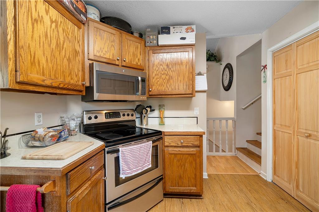 30 Azalea Drive Southeast Cartersville, GA 30121 - Photo 12 of 35 a kitchen with stainless steel appliances granite countertop a stove a sink and a microwave