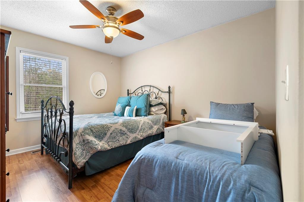 30 Azalea Drive Southeast Cartersville, GA 30121 - Photo 22 of 35 a bedroom with two beds and a chandelier