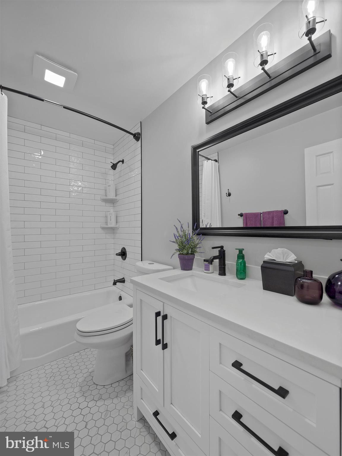10306 Church Hill Road Myersville, MD 21773 - Photo 23 of 81 a bathroom with a toilet a sink a tub a mirror and vanity
