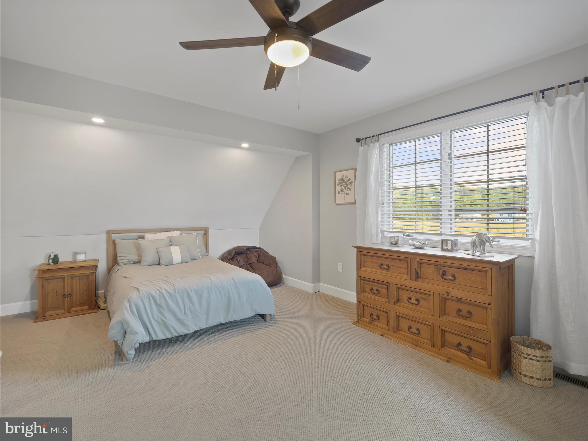 10306 Church Hill Road Myersville, MD 21773 - Photo 30 of 81 a bedroom with a bed and a chandelier fan