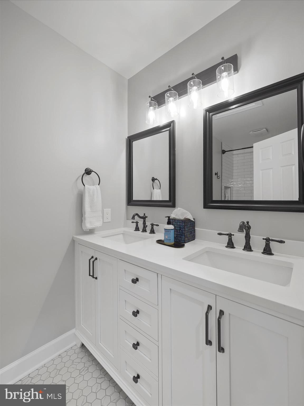 10306 Church Hill Road Myersville, MD 21773 - Photo 32 of 81 a bathroom with a double vanity sink and mirror