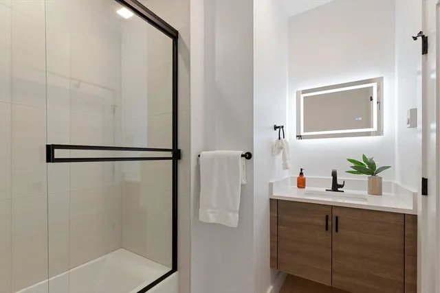 a bathroom with a shower and a sink