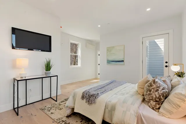 a bedroom with a bed and a flat screen tv