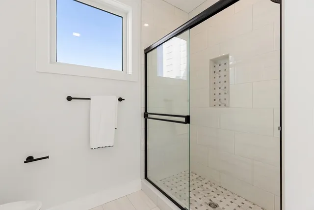 a bathroom with a shower and a sink