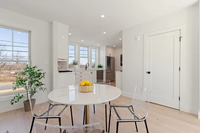 a view of dining room and kitchen with a table chairs