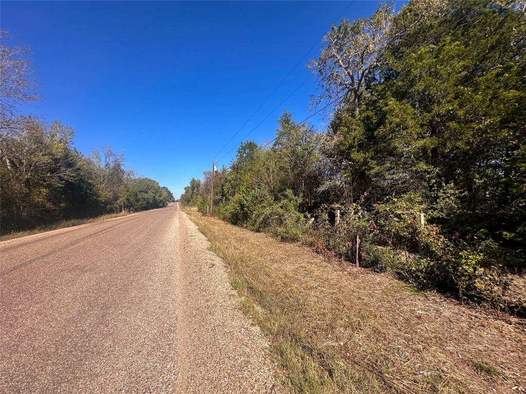Lot 9 Foothill Road Bastrop, TX 78602 - Photo 5 of 12 a view of a road with a trees in the background