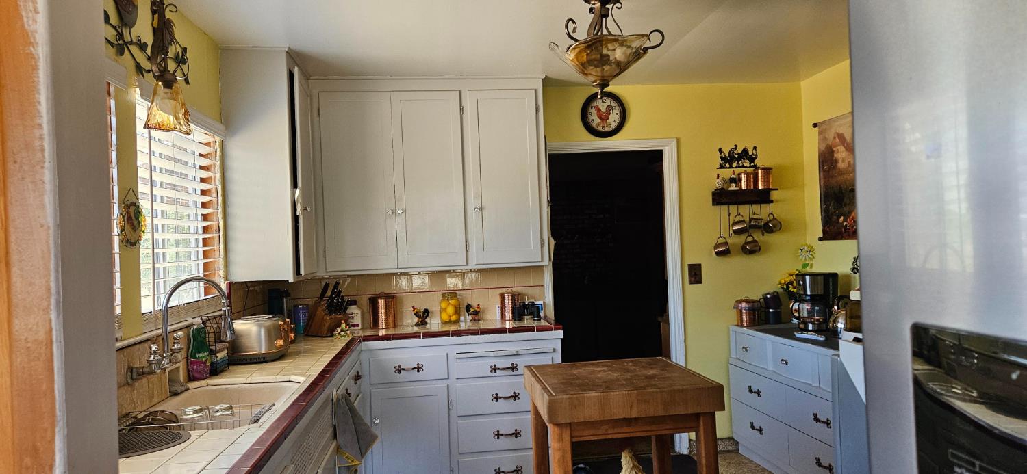 20822 Disch Road Lockeford, CA 95237 - Photo 10 of 30 a kitchen with stainless steel appliances granite countertop a stove and a refrigerator