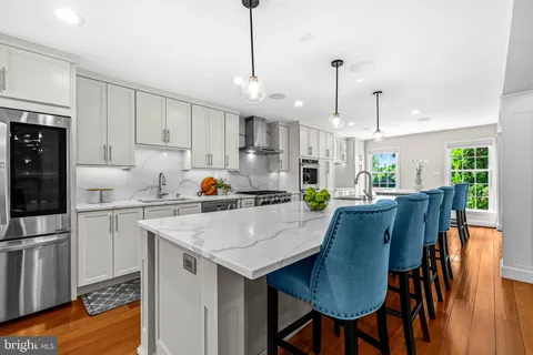 a kitchen with stainless steel appliances granite countertop a stove and a sink