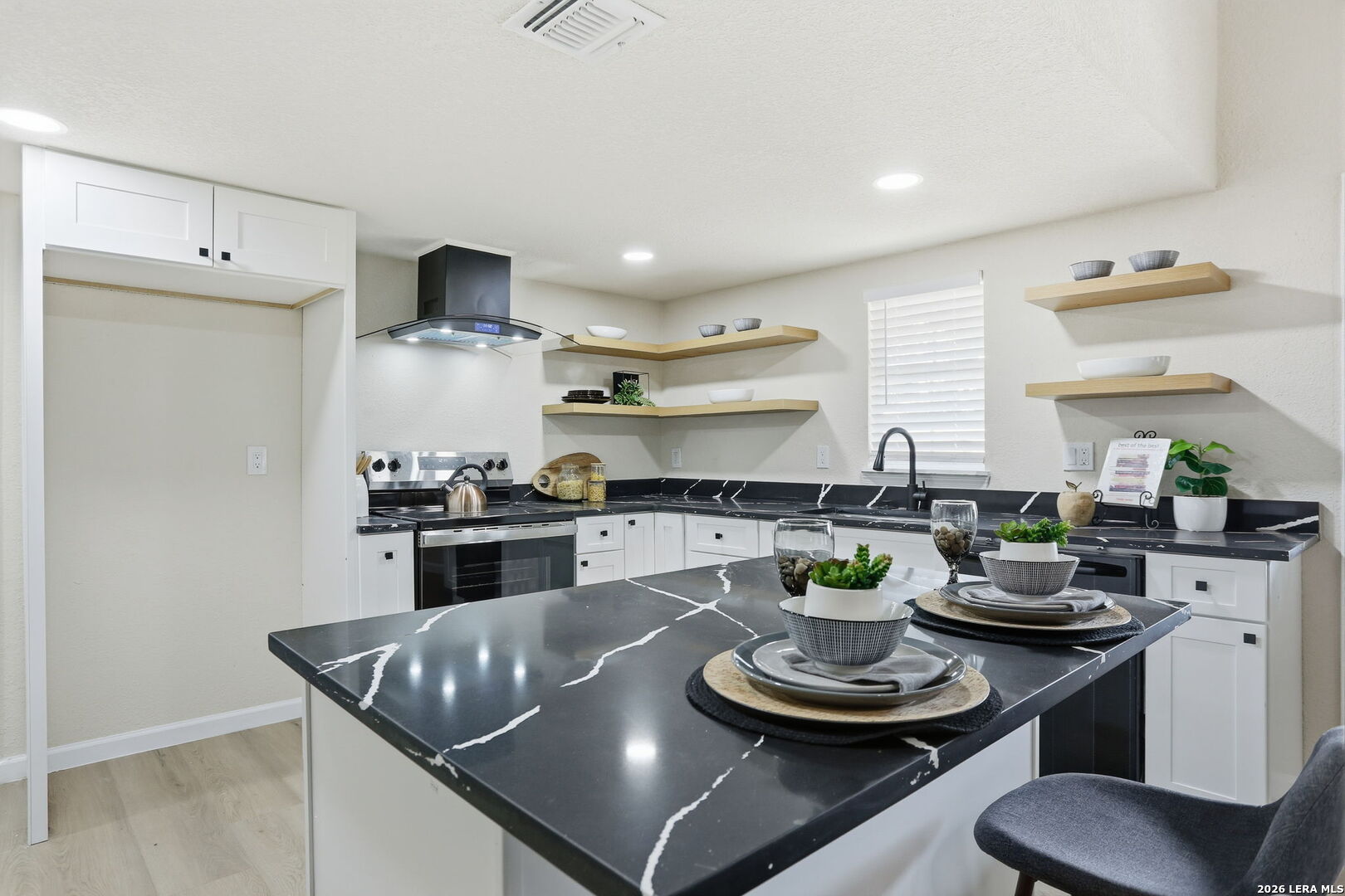 13403 Centerbrook Universal City, TX 78148 - Photo 12 of 30 a kitchen with a stove and white cabinets