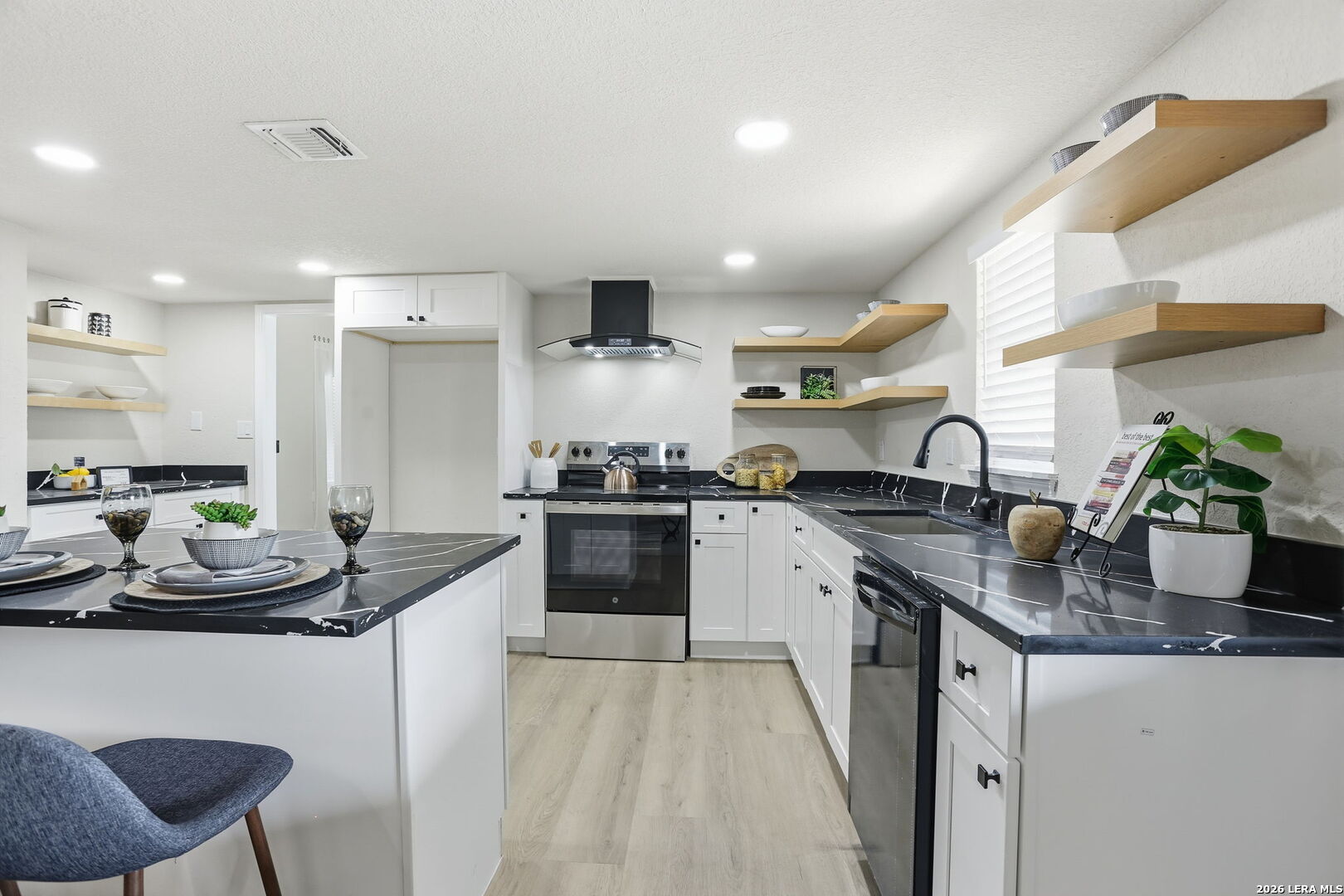 13403 Centerbrook Universal City, TX 78148 - Photo 13 of 30 a kitchen with granite countertop a sink and cabinets
