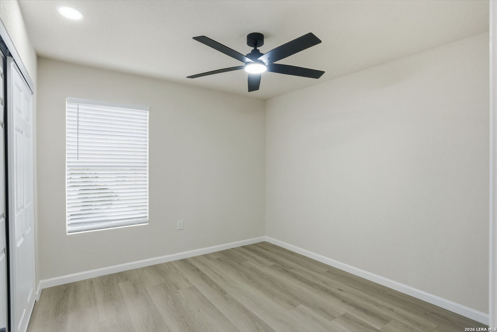 13403 Centerbrook Universal City, TX 78148 - Photo 20 of 30 an empty room with wooden floor and windows