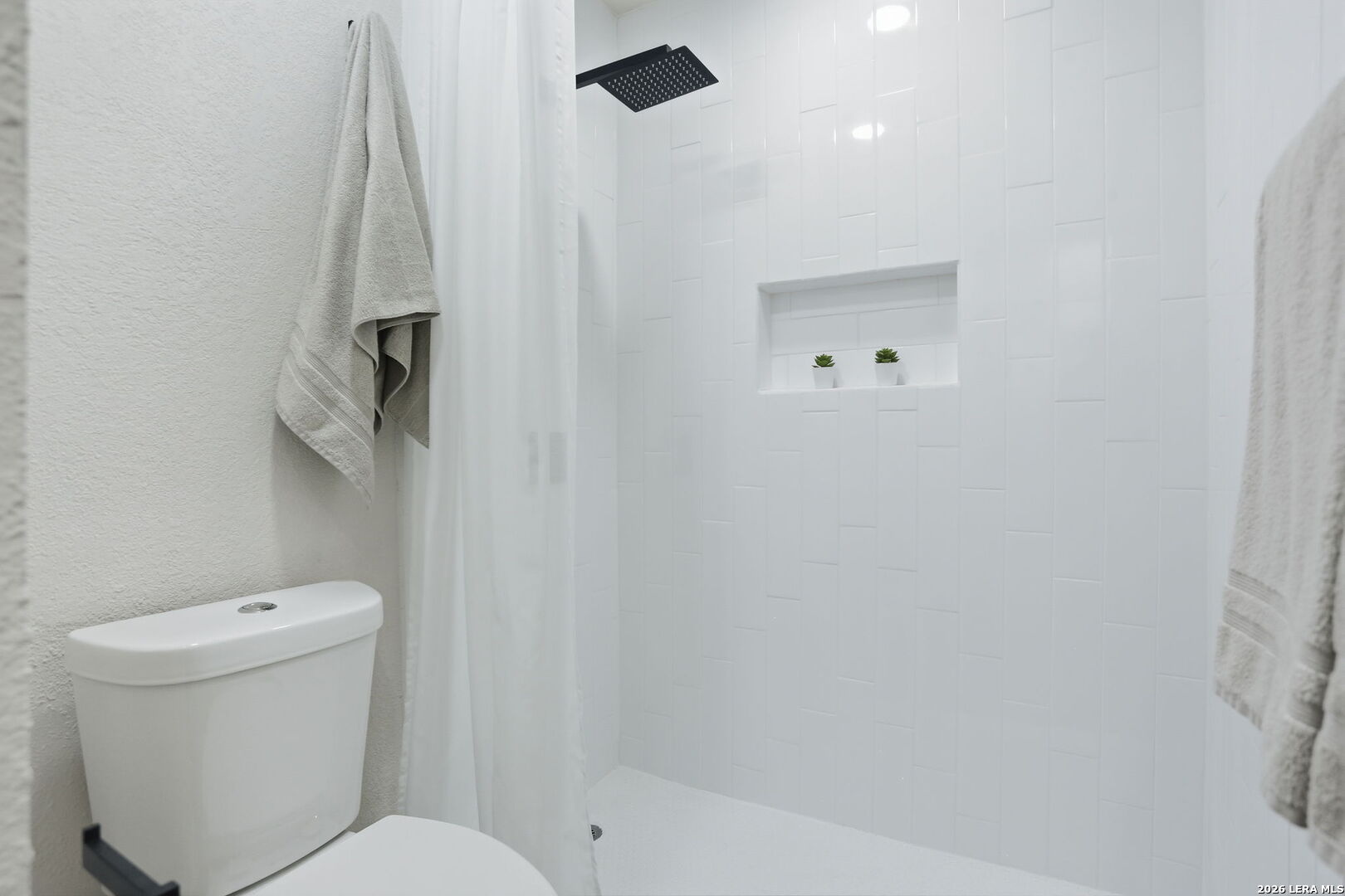 13403 Centerbrook Universal City, TX 78148 - Photo 22 of 30 a bathroom with a toilet and a shower
