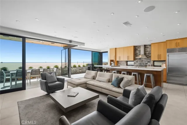 a living room with furniture wooden floor and a large window