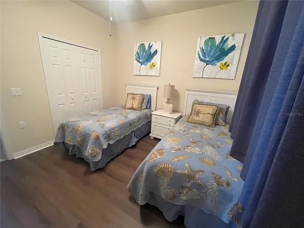 a bedroom with bed and wall painting
