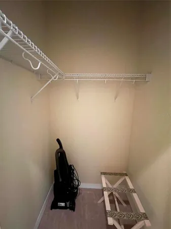 a view of a balcony with chairs and wooden floor