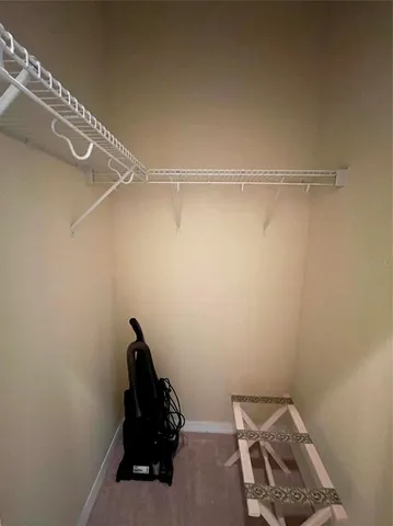 a view of a balcony with chairs and wooden floor