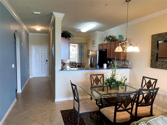 a view of a dining room with furniture and chandelier