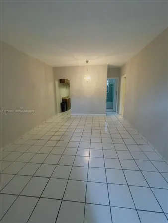a view of a livingroom with an empty space and a fireplace